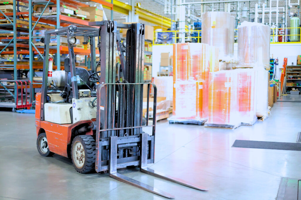 forklift with a media and parts warehouse in the back